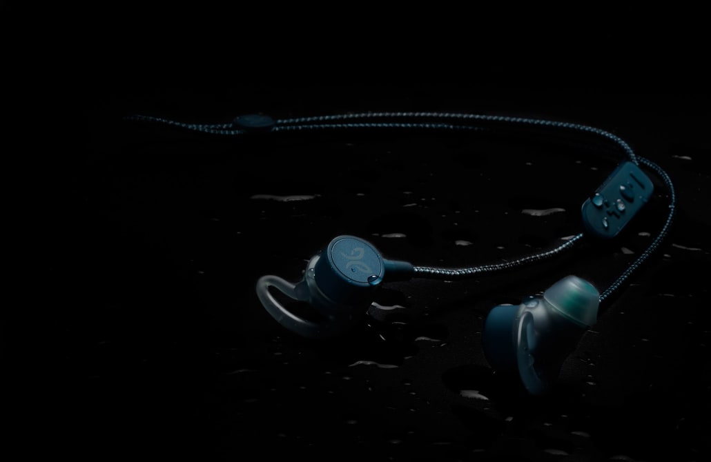 The Tarah Pro wireless earphones shown with water droplets for its IPX7 water resistant design